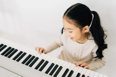 a girl practicing piano